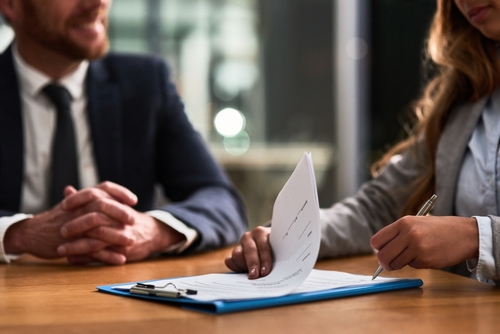 Two people working with a form