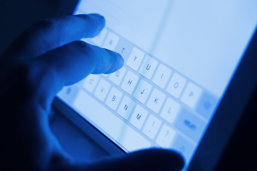 Person typing on an iPad