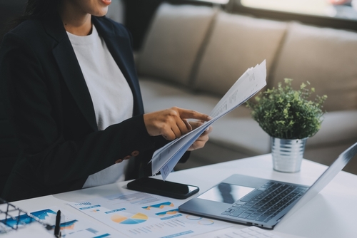 Business woman looking at Information Sheets