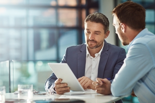 Two men looking an at iPad