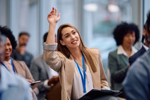 Woman asking a questions at a conference